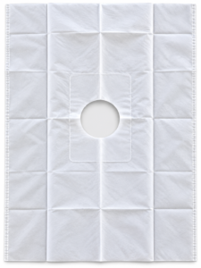 White disposable underpad with a circular central hole and stitched border, laid flat as a sheet.